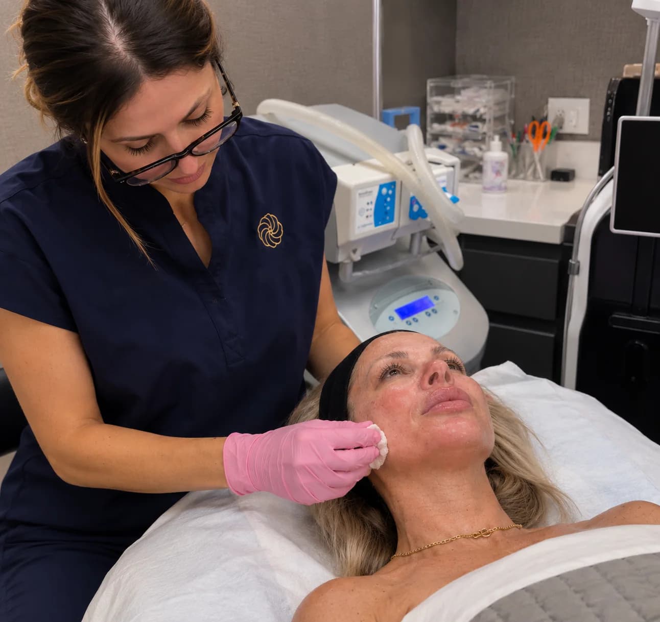Maria preparing a guest's skin for a facial treatment
